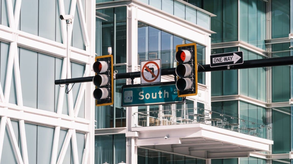 Contemporary intersection with traffic signals at South Street, featuring urban architecture and glass buildings.
