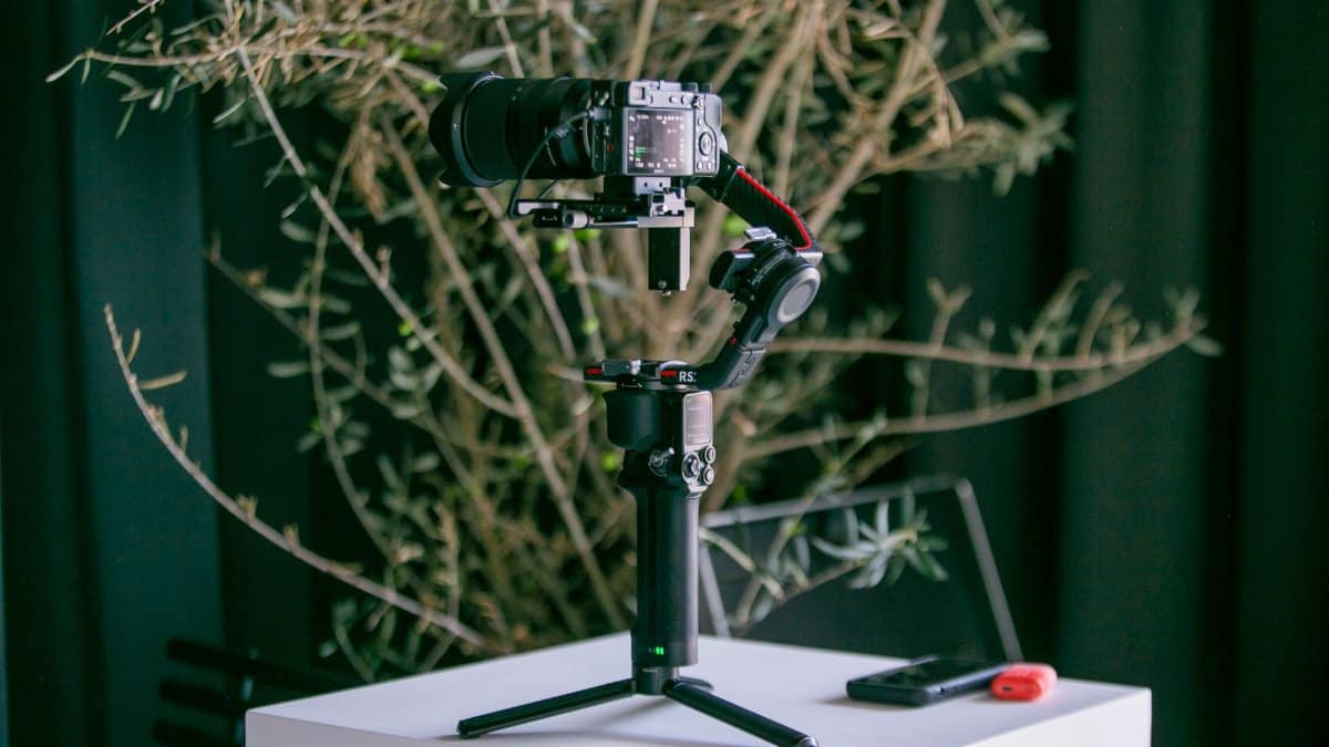Professional camera mounted on a stabilizer with natural indoor background, ideal for photography enthusiasts.
