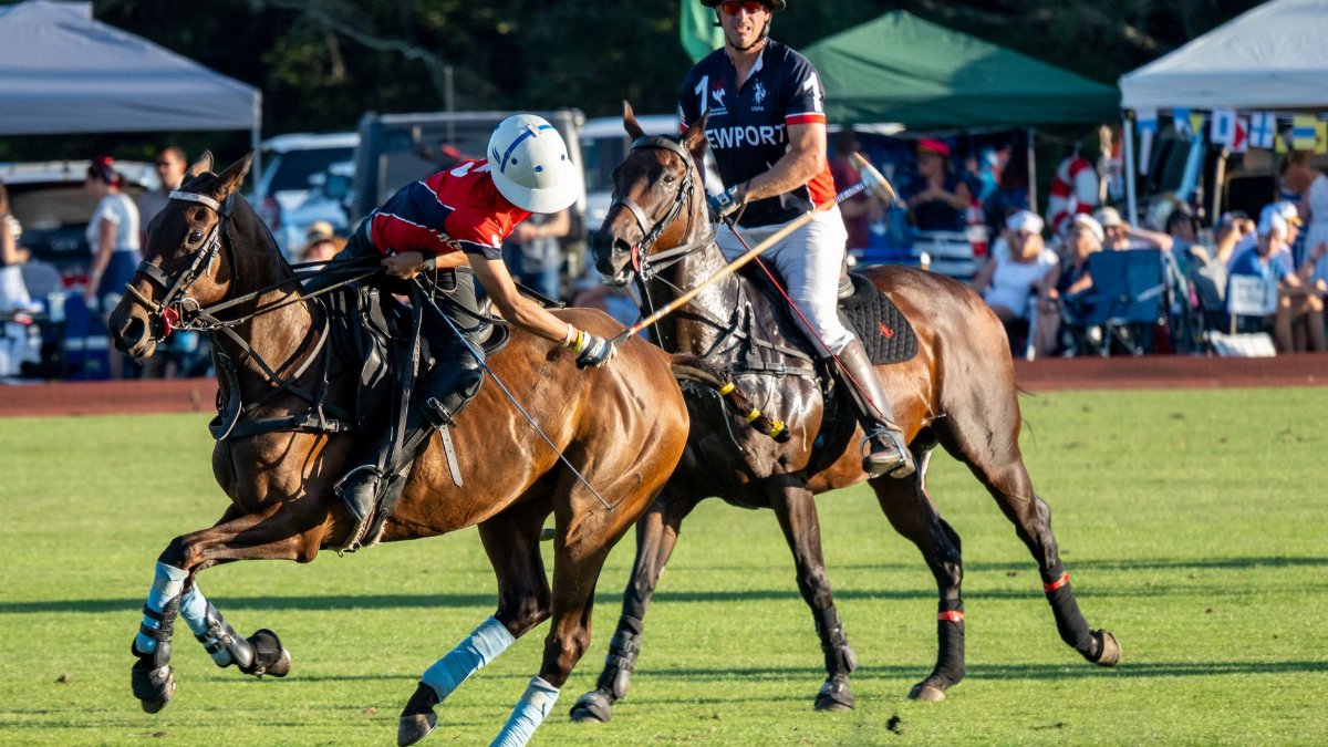 Exciting action shot from a polo match in Portsmouth, Rhode Island, capturing speed and teamwork on the field.