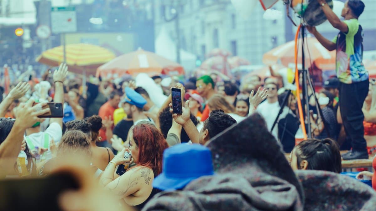 A lively street festival with a diverse crowd enjoying music and festivities outdoors.