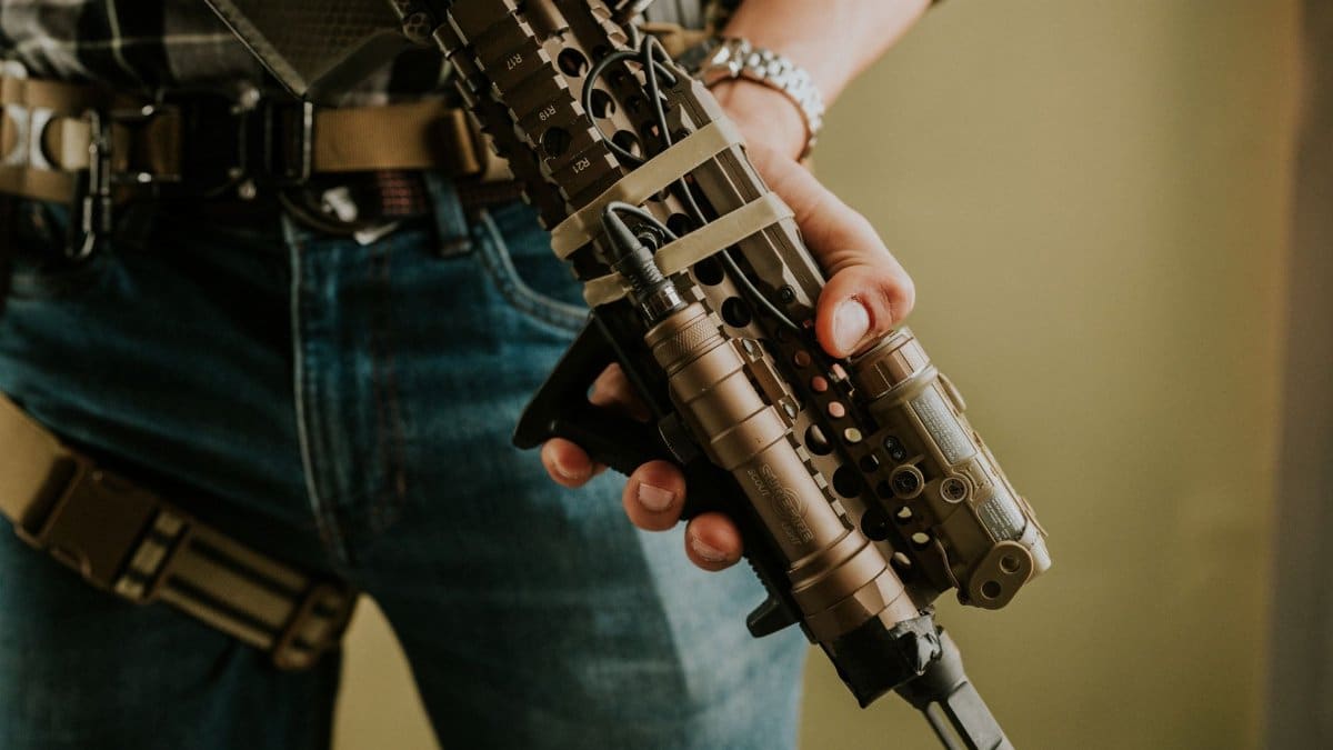 Detailed image of tactical gear and rifle, emphasizing military equipment and strategy.