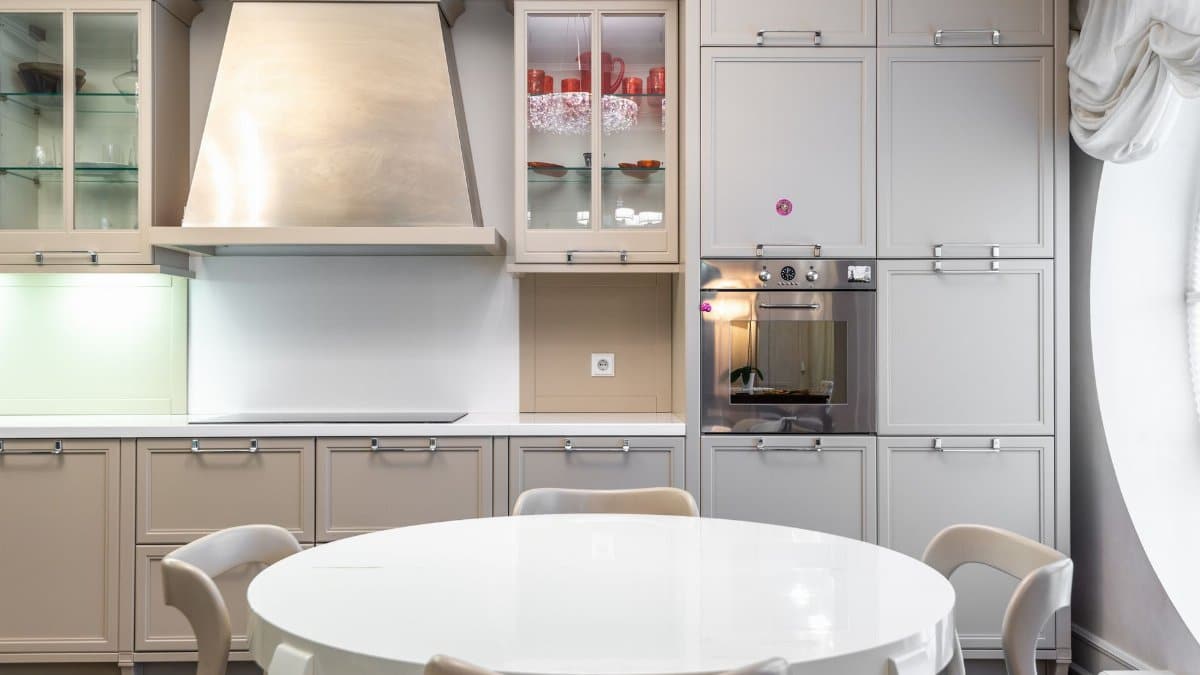Contemporary kitchen with sleek cabinets and a round dining table.