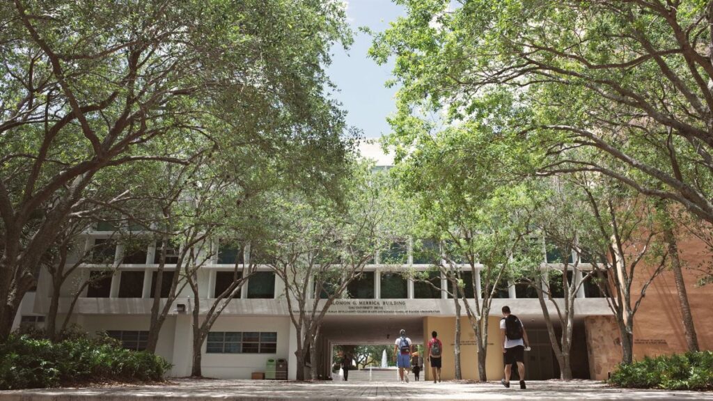 University campus in Coral Gables, Florida, with students walking under a sunny sky.