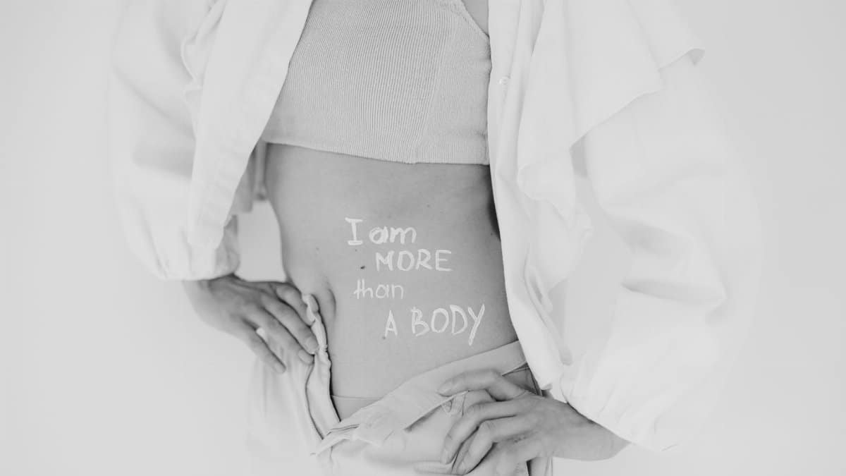 Black and white image promoting body positivity with 'I am more than a body' message.