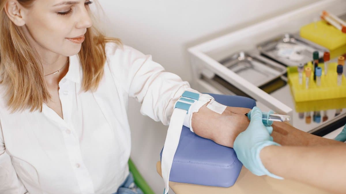 Healthcare professional giving an injection in a medical clinic setting.
