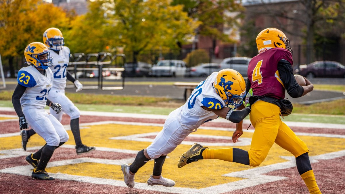 Intense high school football tackle during a game in Baltimore.