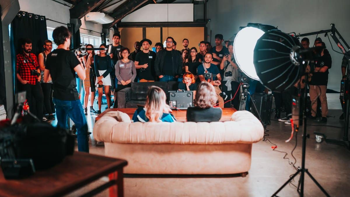 Engaging workshop session with a speaker presenting to an attentive audience in an urban studio setting.