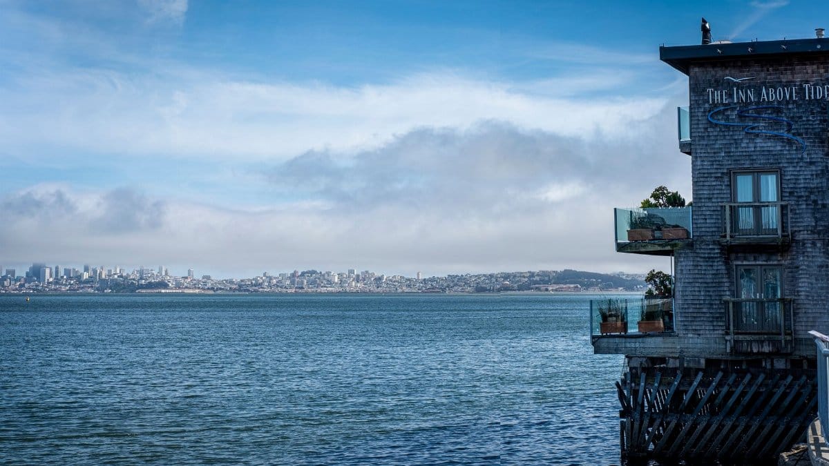 Scenic view of Sausalito bay overlooking San Francisco skyline and waterfront hotel.