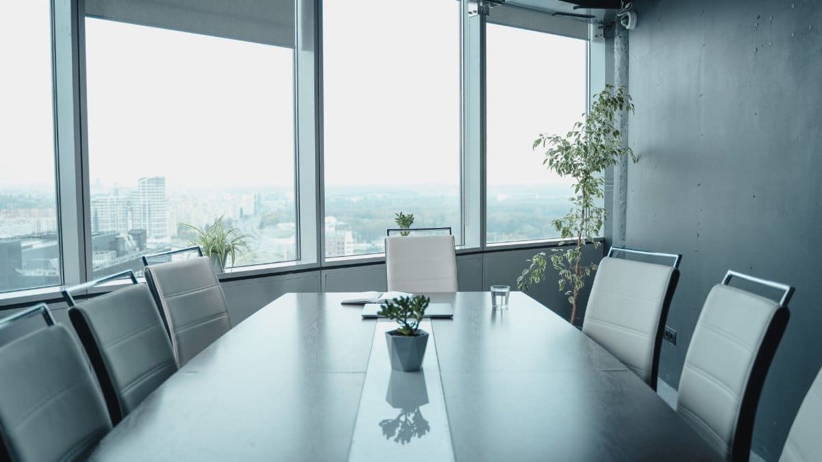 Spacious conference room with panoramic city views and elegant furnishings.