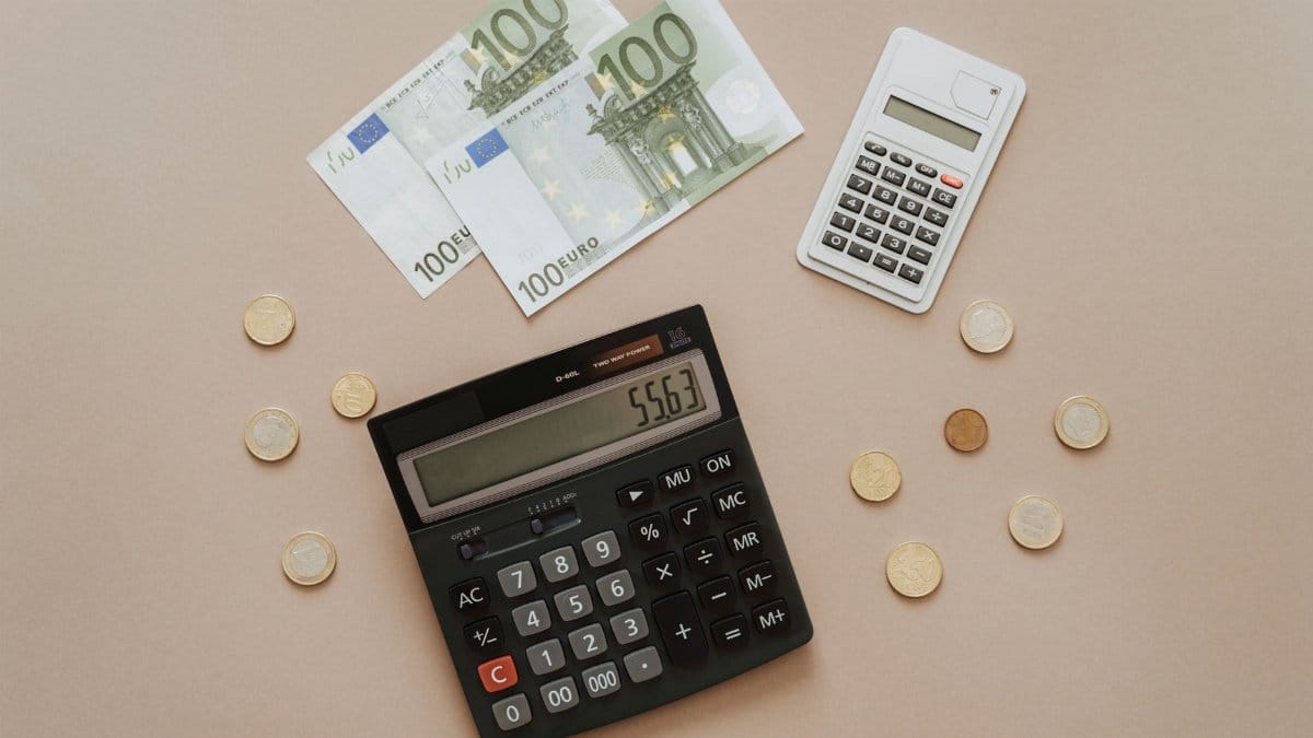 Flat lay of calculators and Euro currency, depicting financial calculations and budget management.