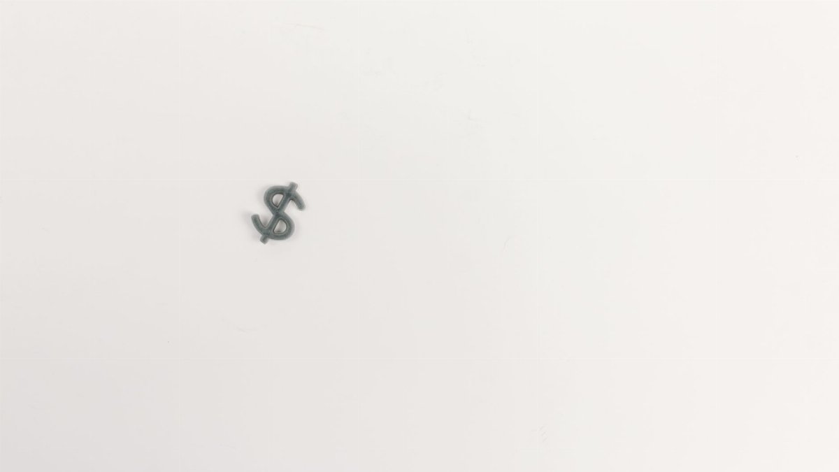 Close-up of a dollar symbol on a white background, symbolizing economy.