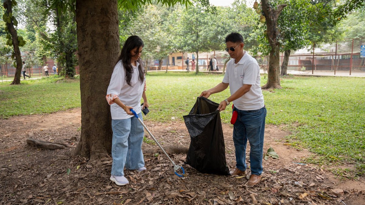 A group of volunteers cleaning up a park, promoting environmental awareness and community service.