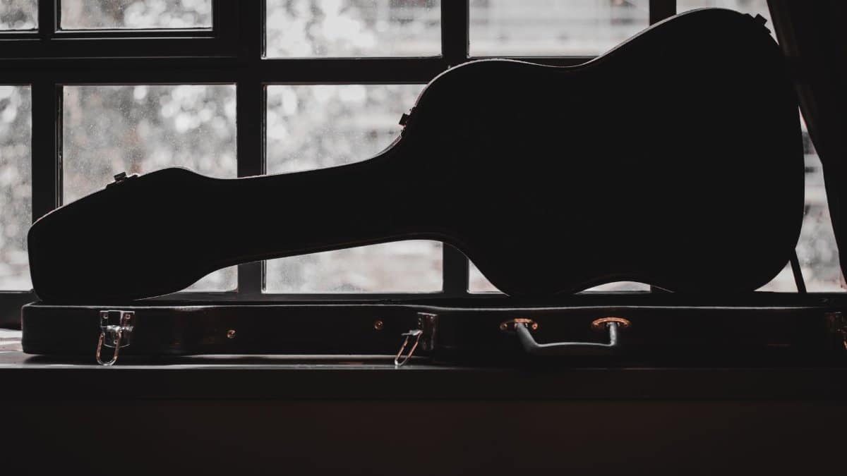Silhouette of a violin case in front of a window, showcasing musical elegance.