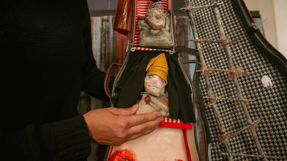 Colorful handmade puppets displayed inside a custom case, highlighting unique craftsmanship.