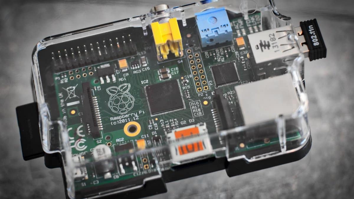 Detailed image of a Raspberry Pi microcomputer circuit board in a clear case.