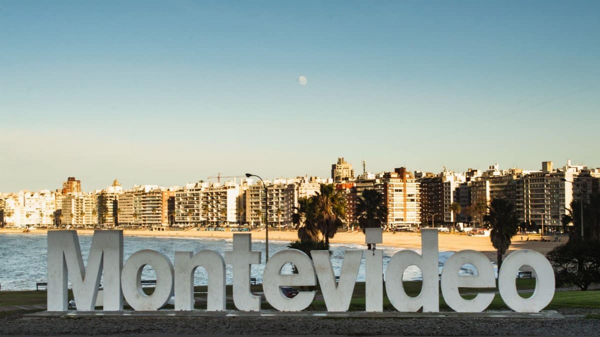 Montevideo landmark sign with city skyline and beach view, capturing Uruguay's iconic coastal urban setting.