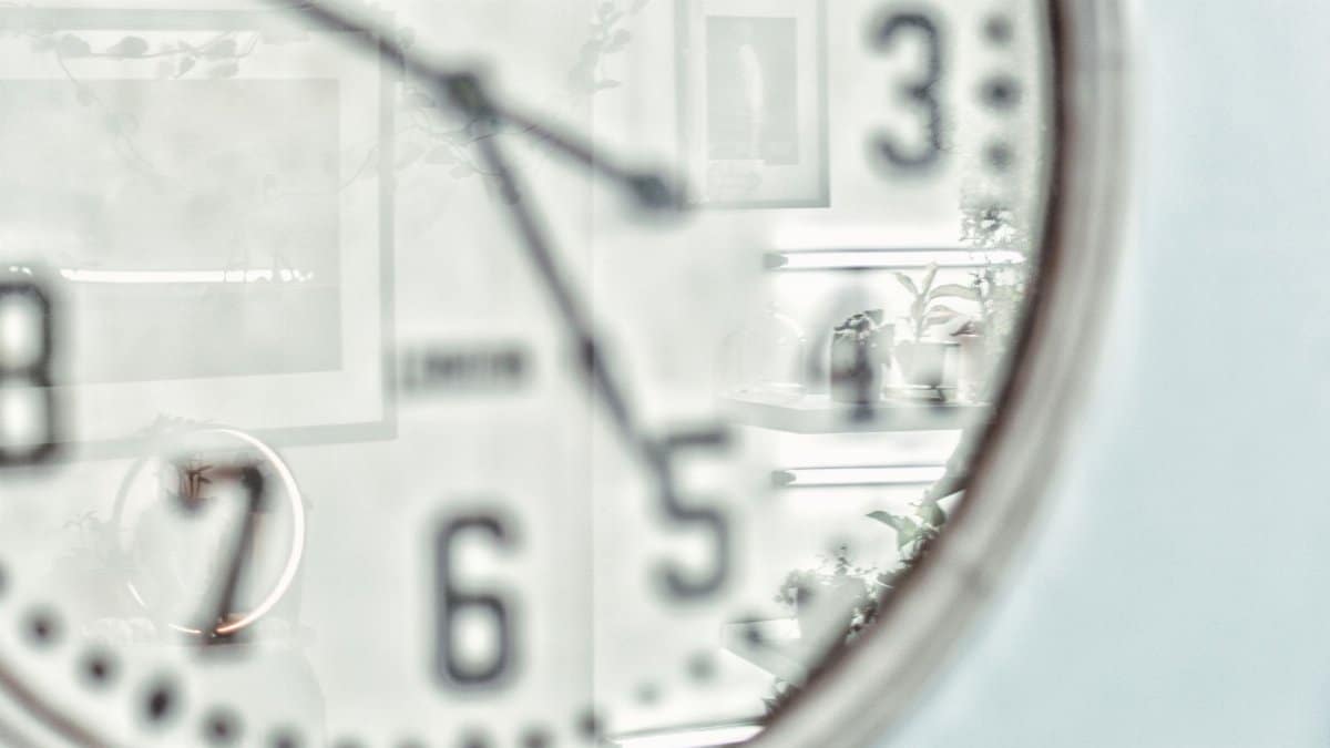 Vintage wall clock with reflection creates an artistic still life impression.