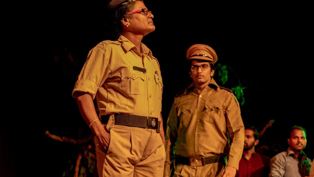 Portrait of Indian police officers in uniform performing on stage.