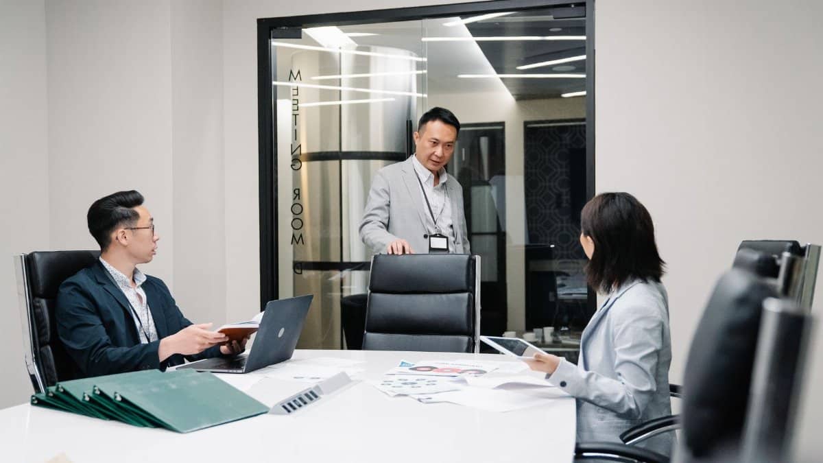 Business professionals in a meeting room engaged in teamwork and strategic planning.
