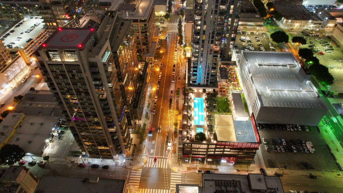 High-rise buildings and streets illuminated in downtown Los Angeles at night.