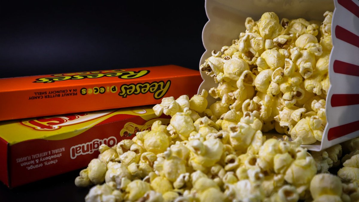 Close-up of spilled popcorn and candy boxes, perfect for snacks or movie night imagery.