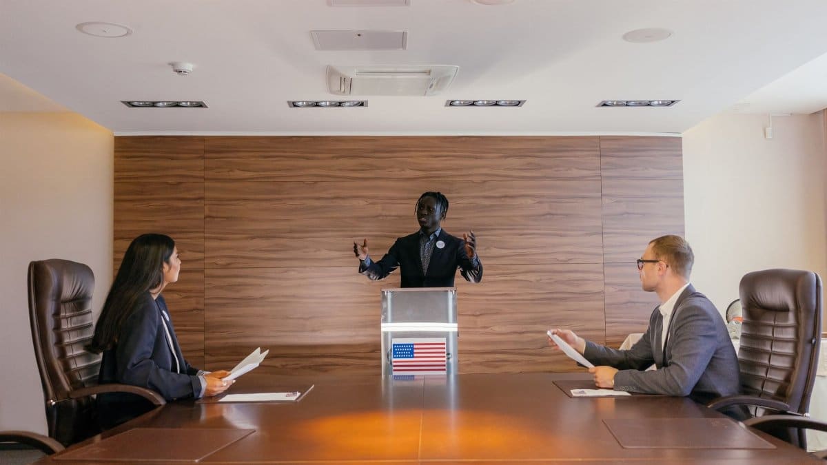 Three professionals deliberating in a modern conference room setting.