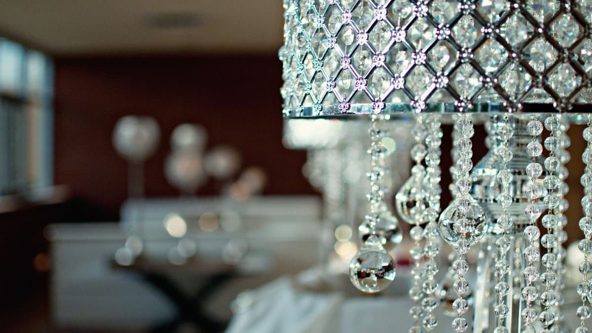 Elegant crystal lamp with intricate designs in a modern living room setting.