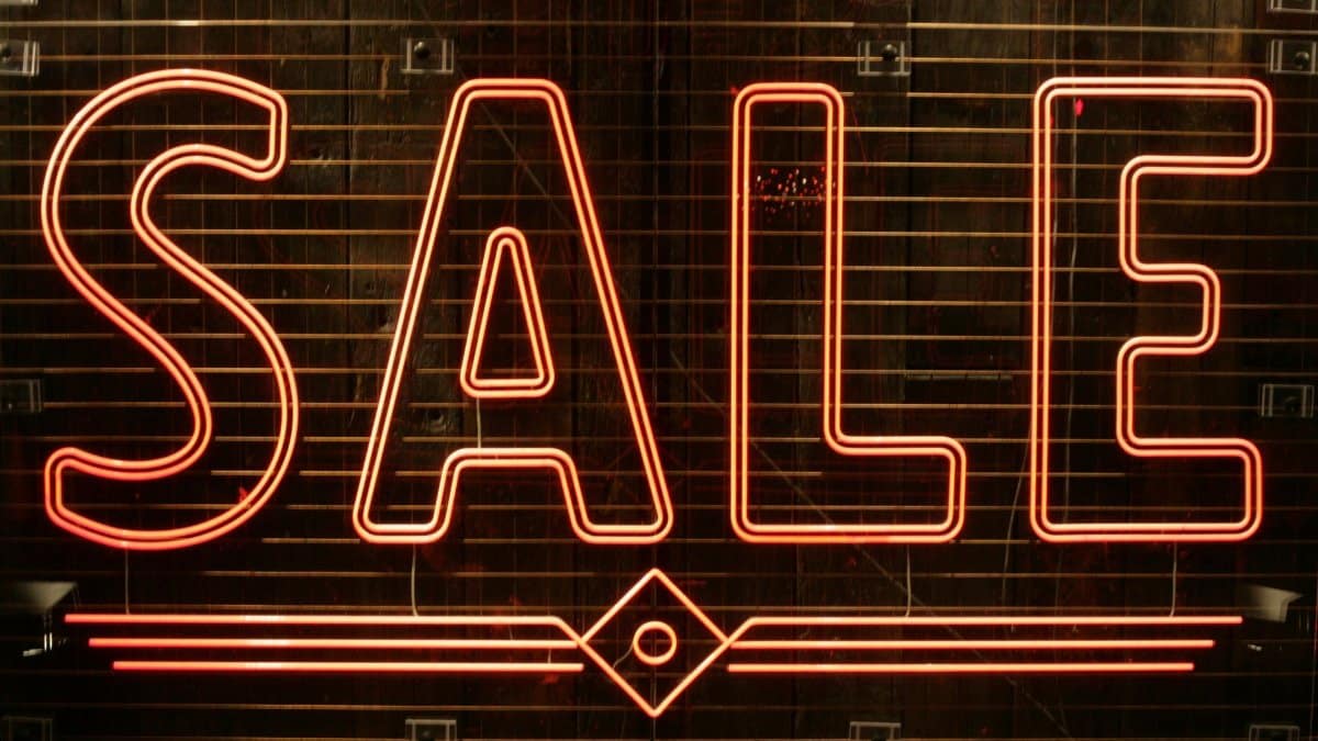 Close-up of a glowing neon SALE sign perfect for retail promotions.