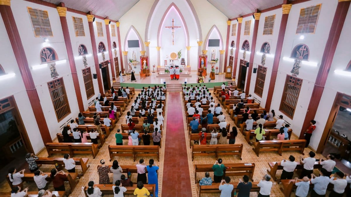 A vibrant congregation gathers in a beautifully lit church for worship.