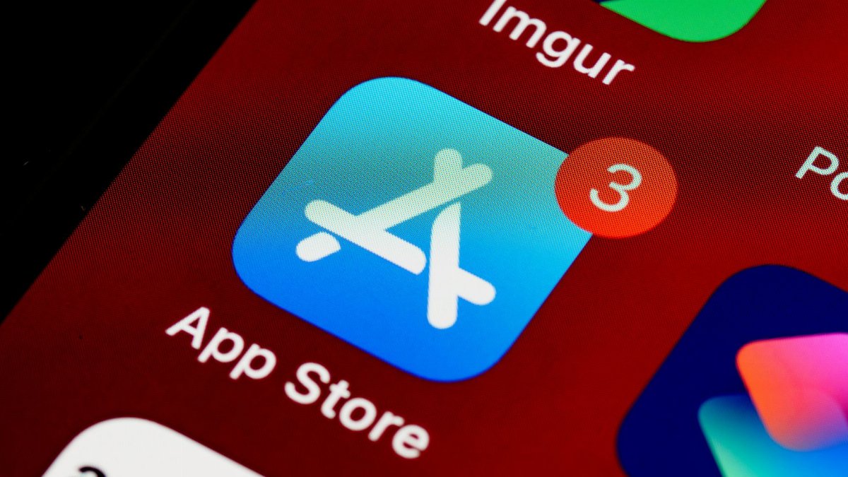 Close-up of App Store icon on iPhone screen with notification badge, highlighting app updates.