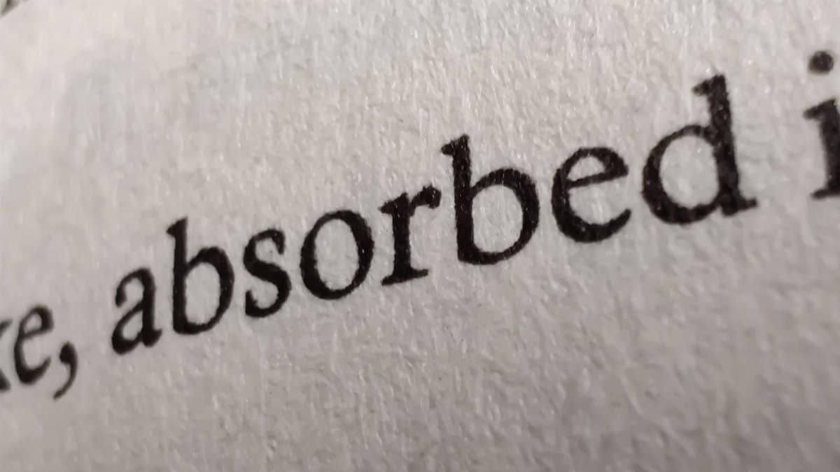 Detailed close-up image of printed text on a textured paper page.