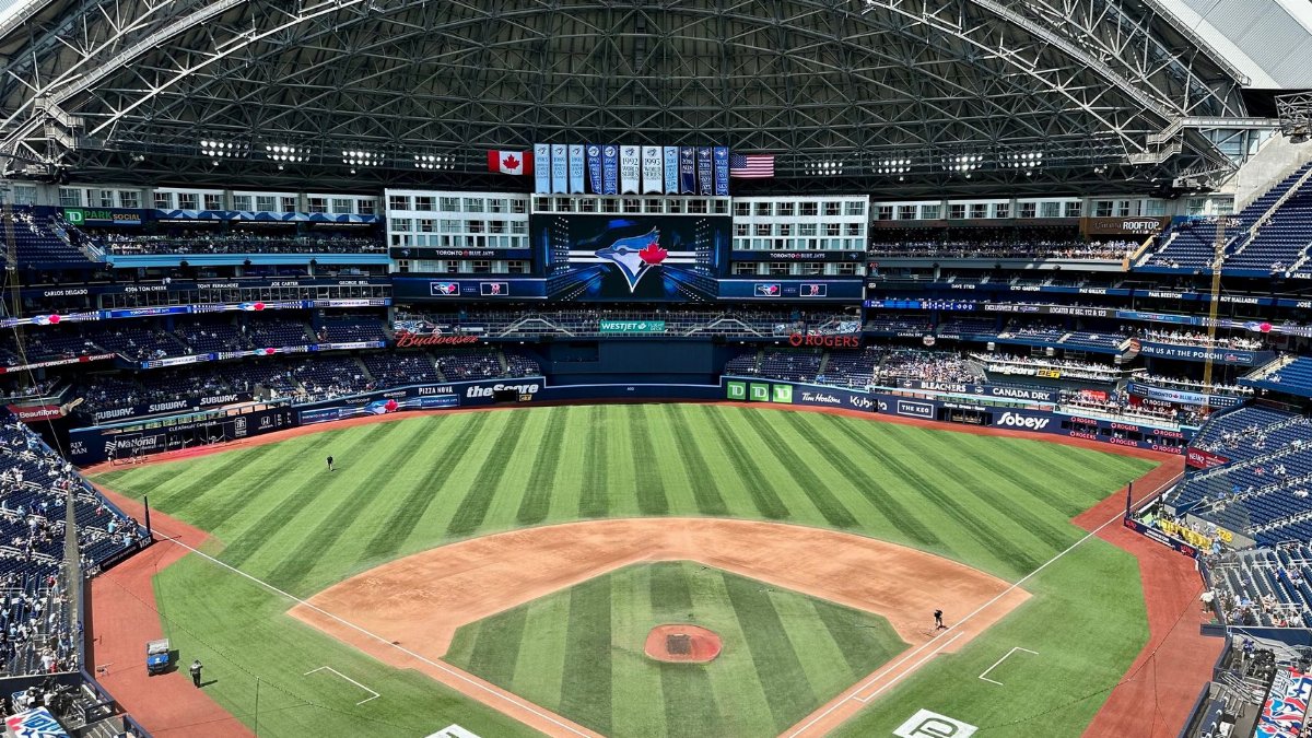 Aerial view of the Rogers Centre stadium during a baseball game in Toronto, displaying its retractable roof.