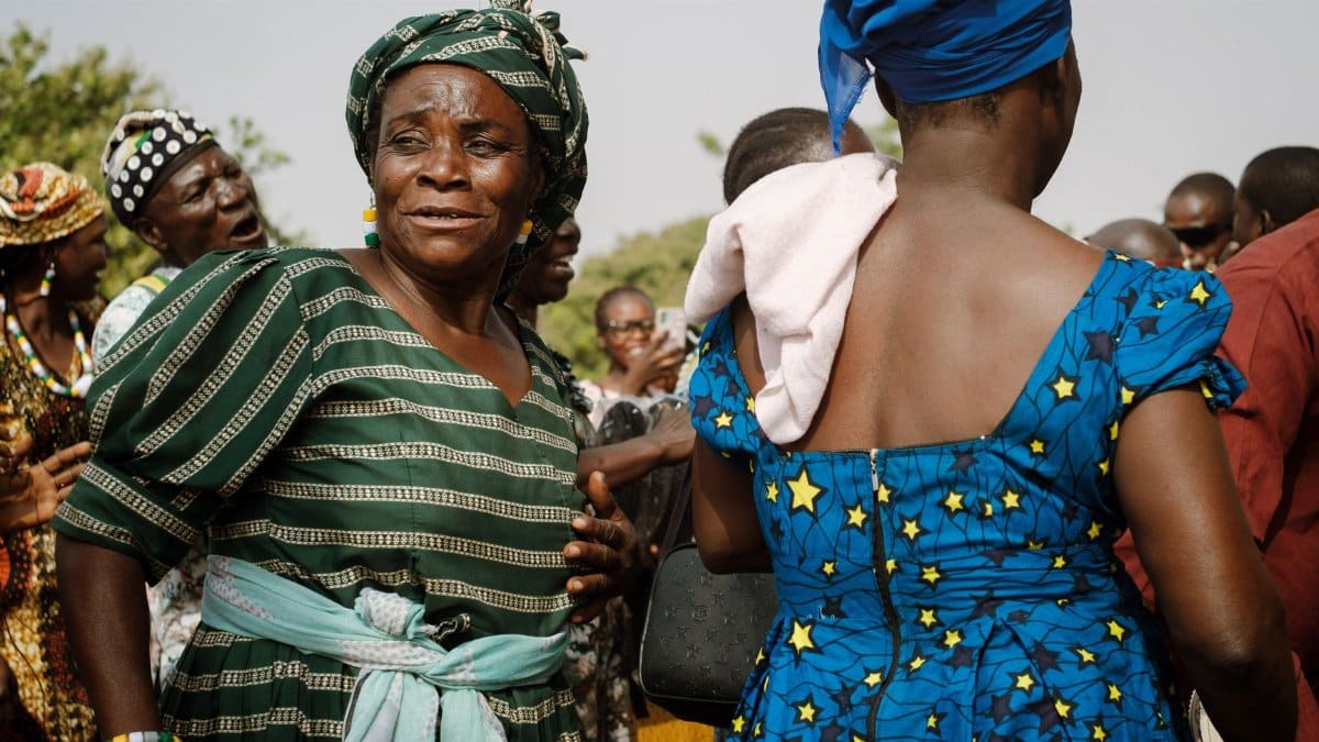 Colorful gathering in Nigeria showcasing traditional attire and joyful expressions.