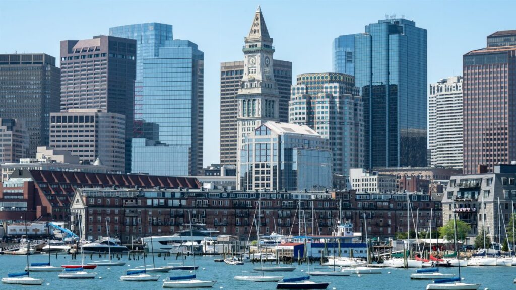 A scenic view of Boston's skyline featuring the iconic Custom House Tower and waterfront.