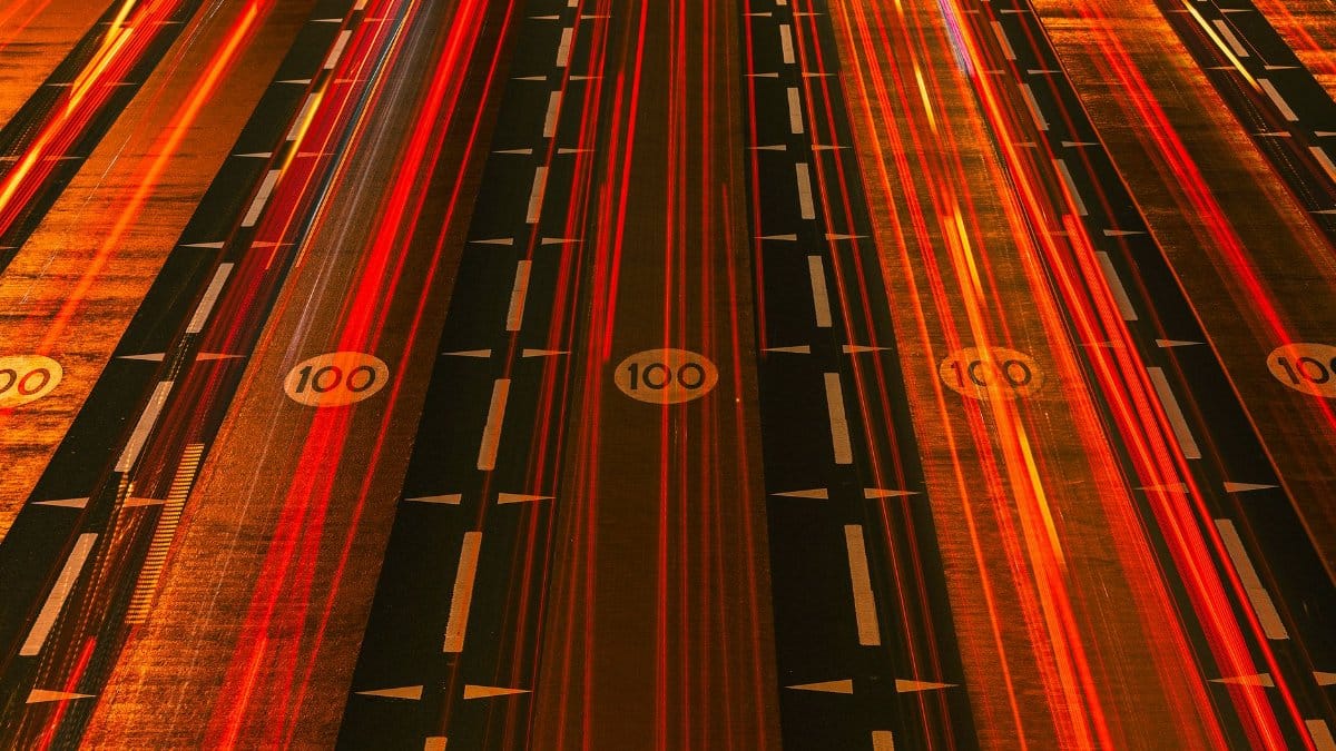 Long exposure night shot of busy expressway in Dubai illustrating urban speed and motion.