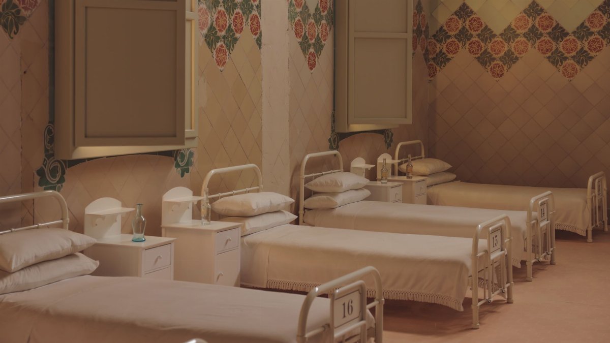 A serene and vintage hospital ward with empty beds in Barcelona.