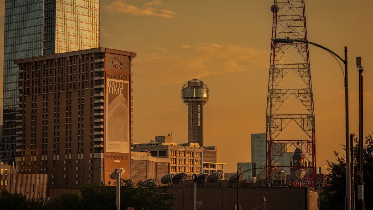 A stunning sunset view of Dallas showcasing Reunion Tower and urban architecture.