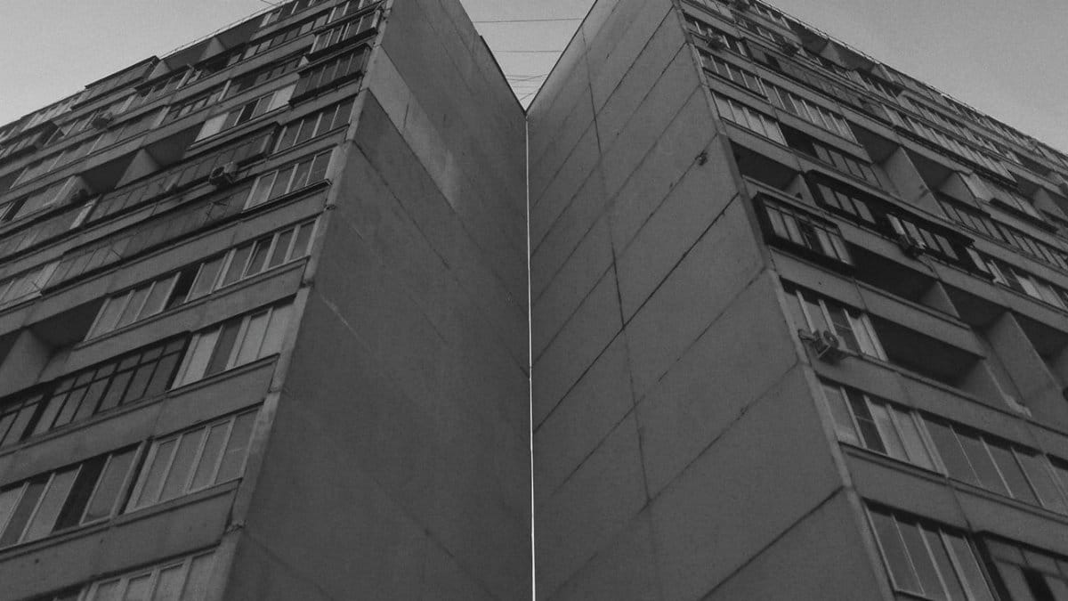 Low angle view of a stark high-rise building in grayscale, showcasing dramatic urban architecture.
