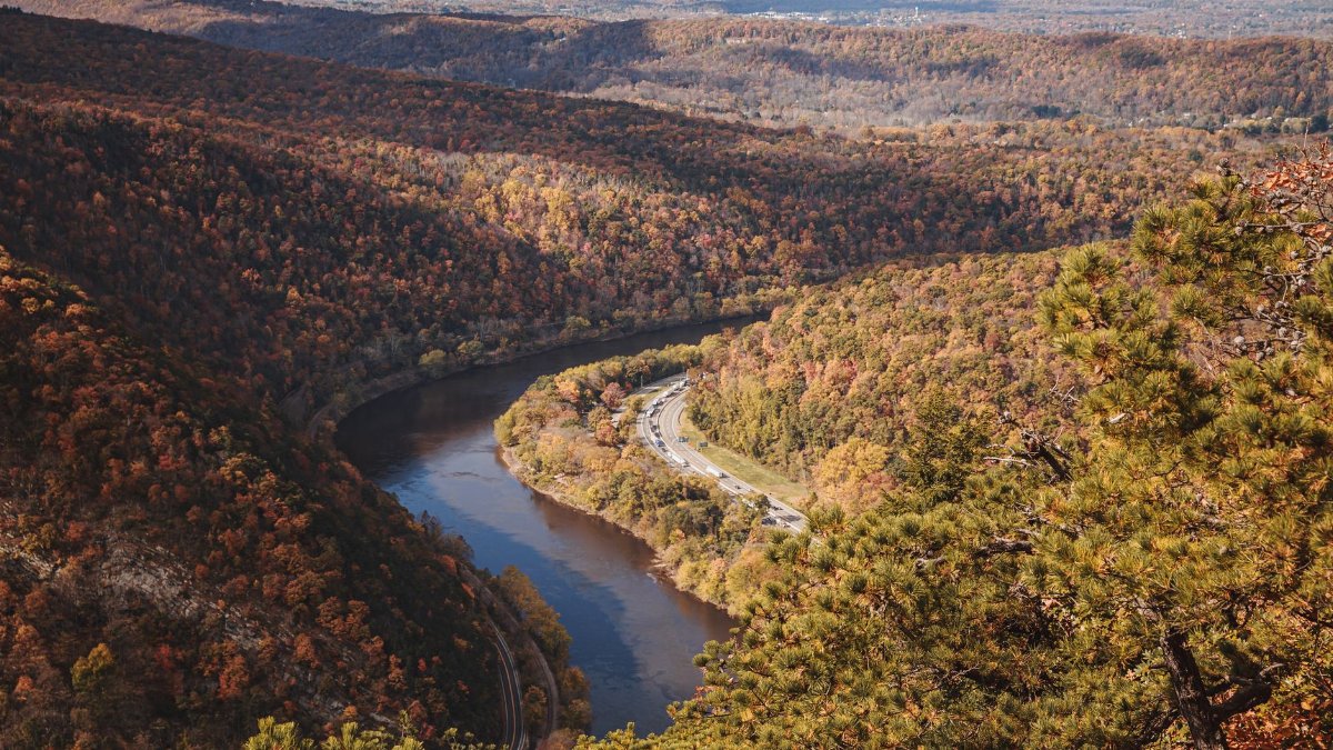 Explore the sweeping autumn landscapes at Delaware Water Gap with vibrant fall foliage and a winding river.