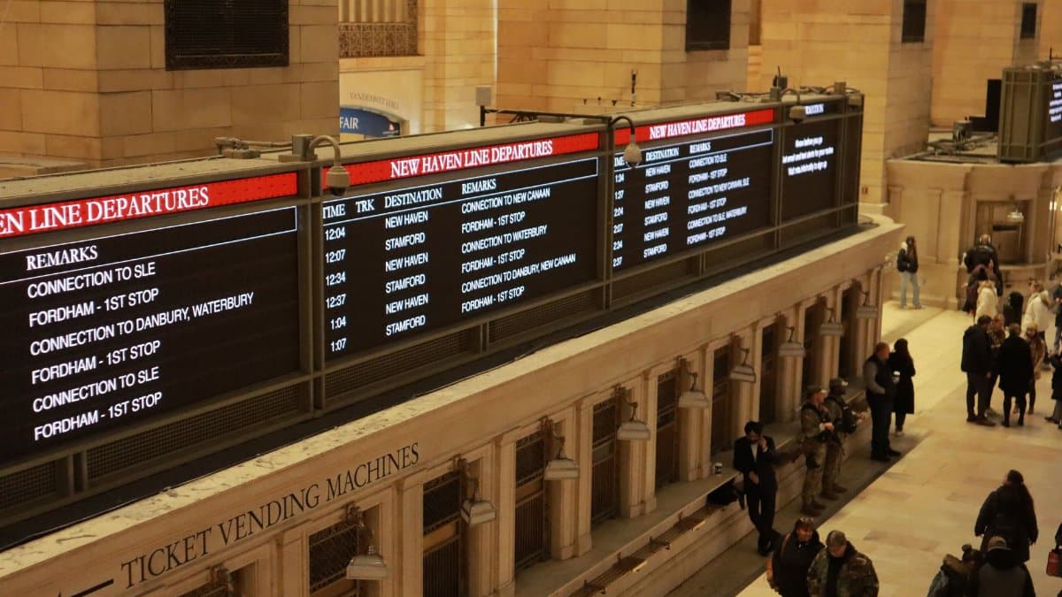 Busy scene at Grand Central Terminal New Haven Line with departure boards.