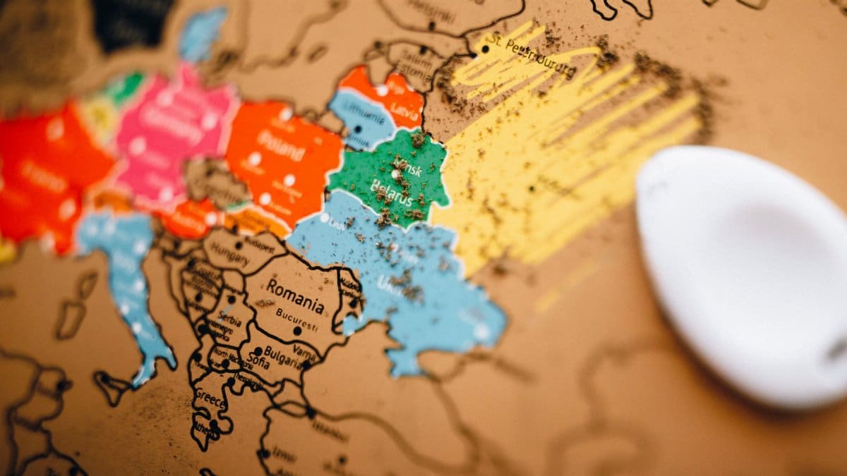 Close-up of a colorful scratch-off world map showing Europe with focus on planning travel.