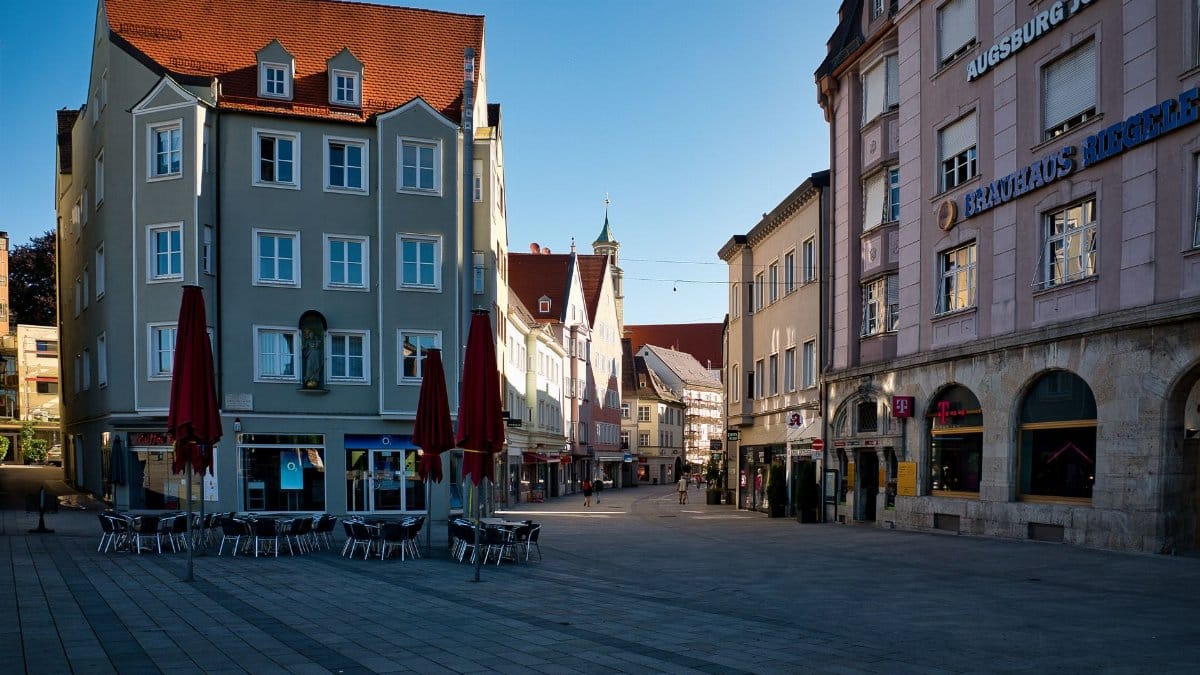 Explore the beautiful architecture of Augsburg's old town square in the early morning light.