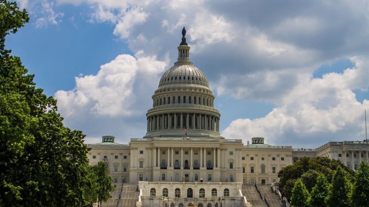 A stunning view of the iconic United States Capitol under a blue sky in Washington, D.C.