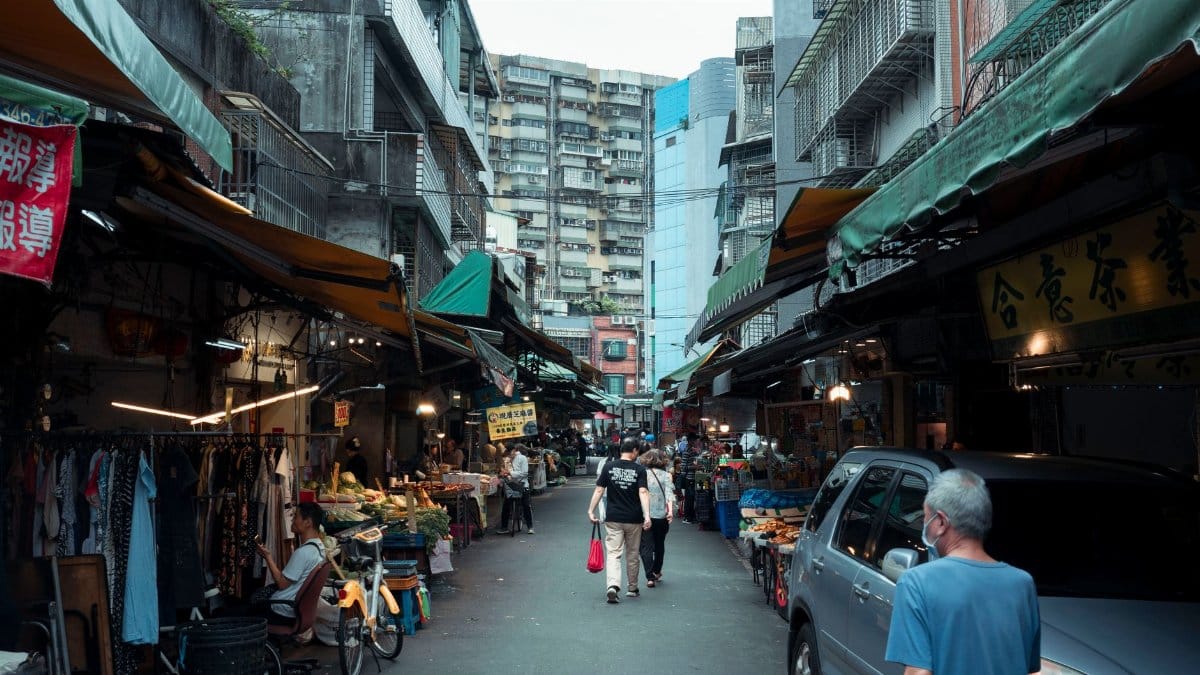 Bustling Taipei street market with shops, people, and urban vibe, capturing local daily life.
