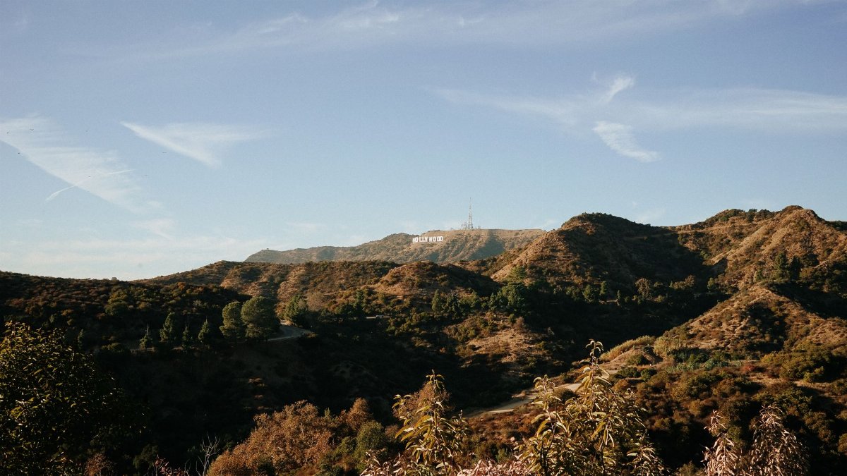 Beautiful landscape view of the Hollywood Hills showcasing the iconic Hollywood sign under a clear blue sky.