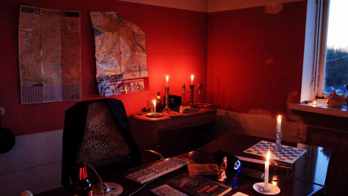 Warm, ambient office scene with candles, maps, and chessboard on a desk. Ideal for tactical brainstorming.