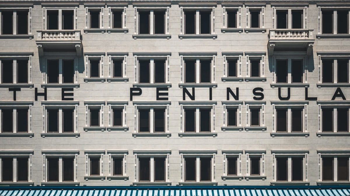 Close-up of The Peninsula Hotel facade in Hong Kong showcasing its unique architectural design.