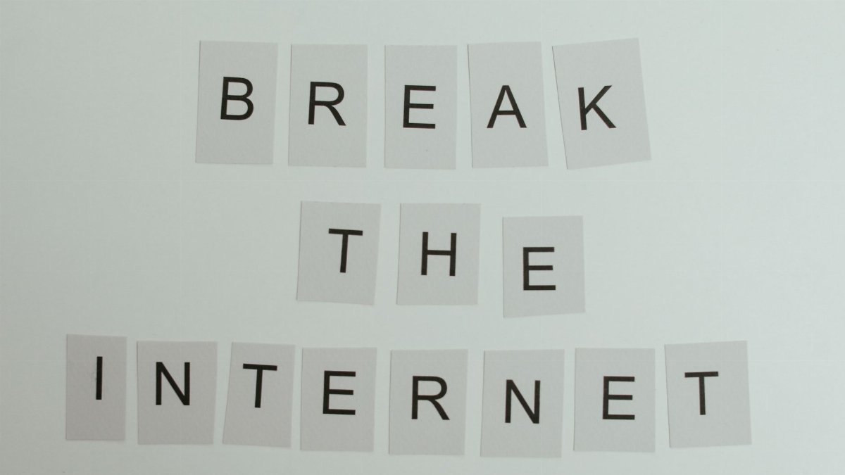 Conceptual image with text 'Break the Internet' using letter cards on a light background.