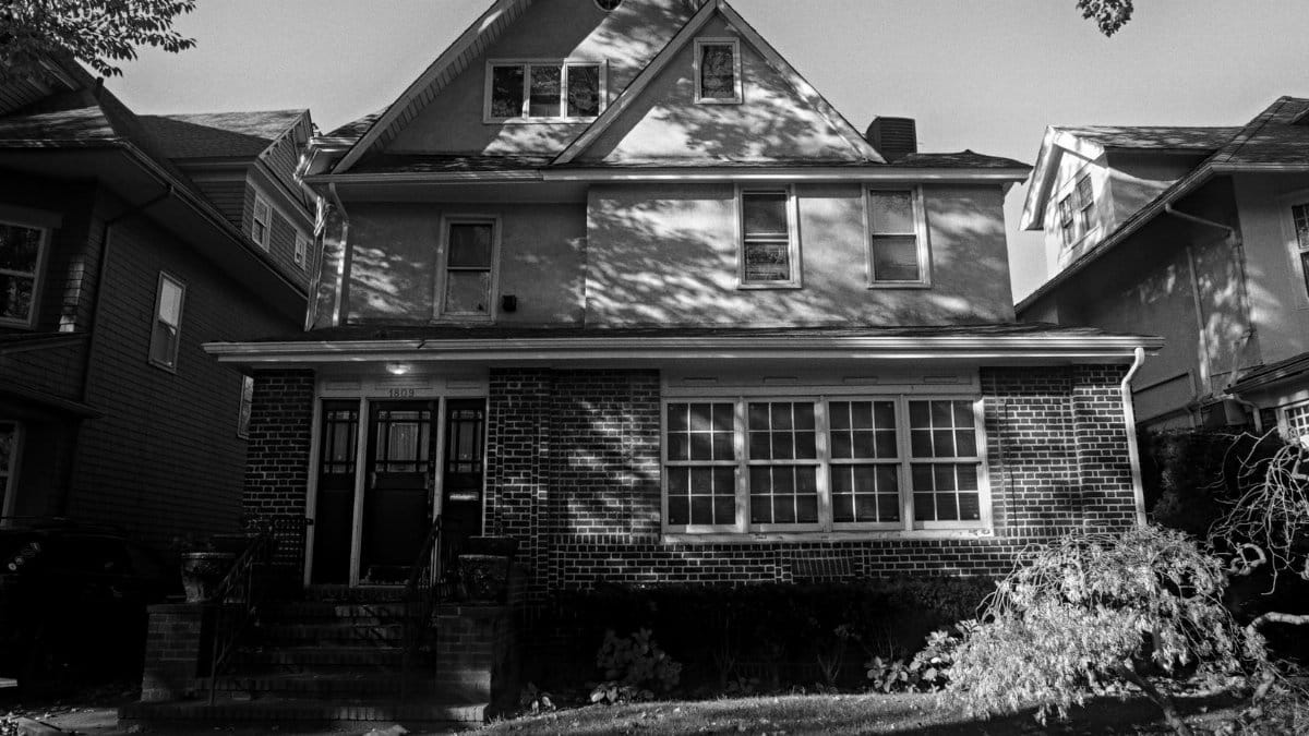 Timeless black and white photo of a suburban New York house with classic architectural details.