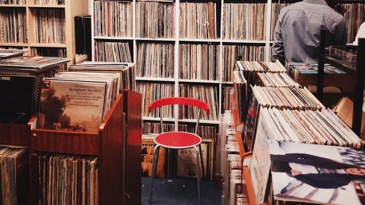 Explore a cozy vintage vinyl record store with wooden shelves in Singapore.